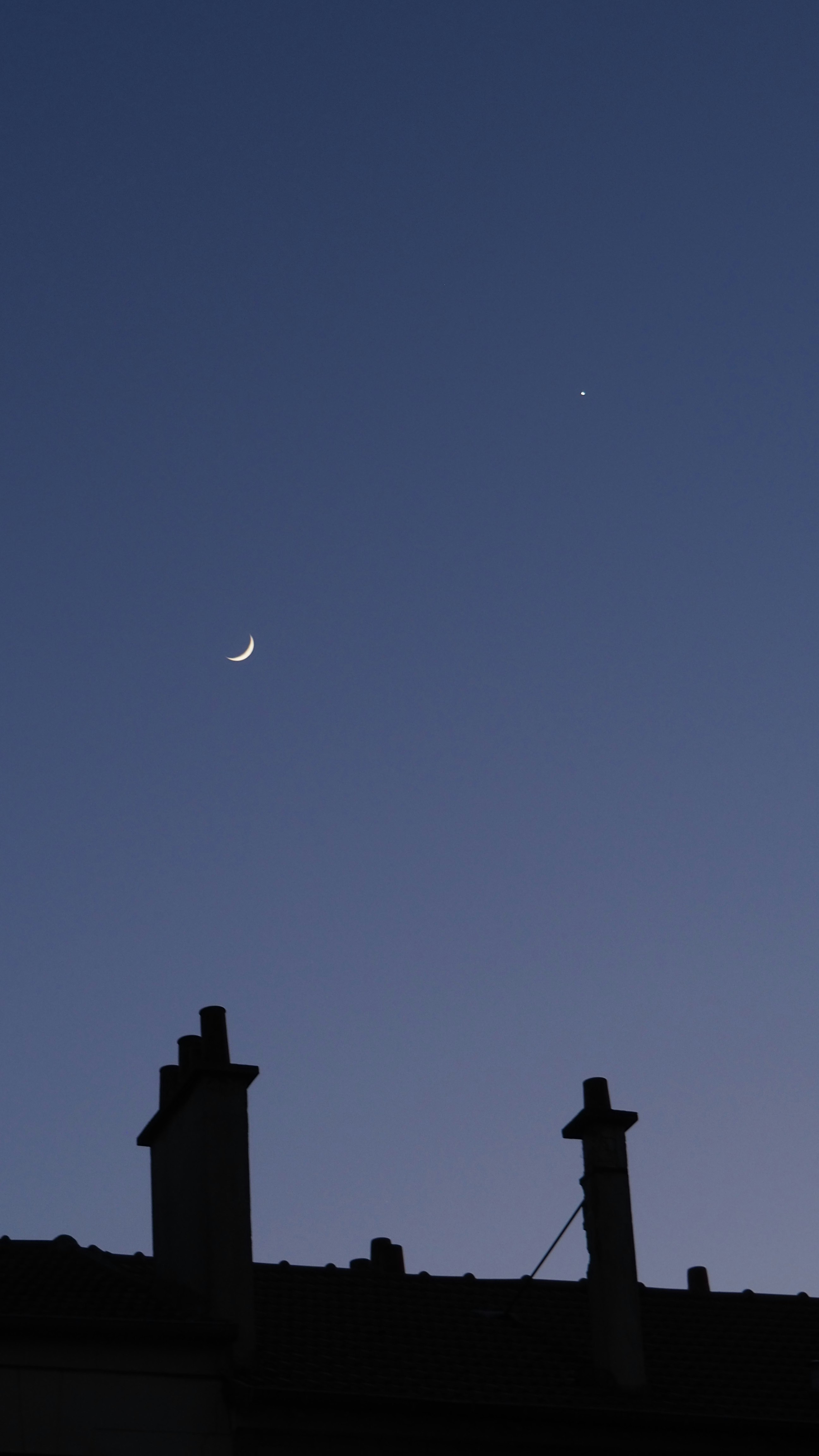 silhouette of building under moon